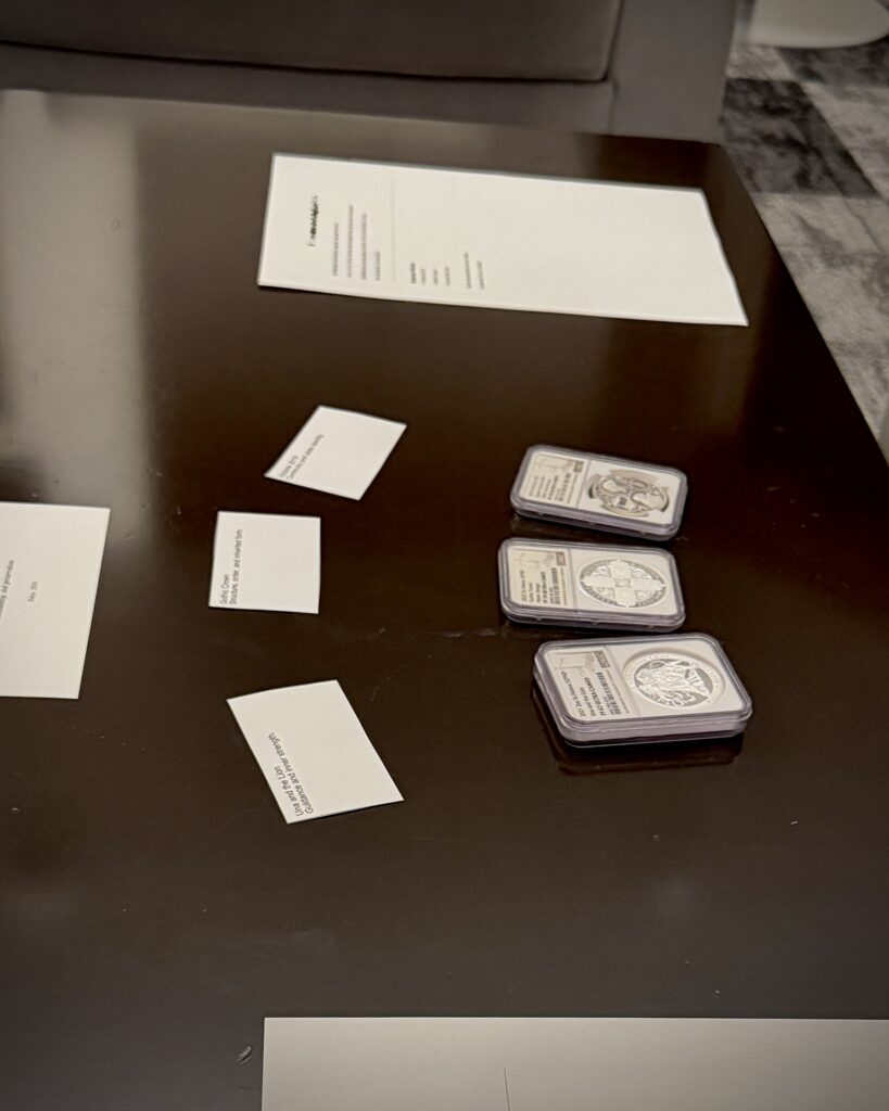 Three British coins, including Una and the Lion, Gothic Crown, and Victoria 2019, displayed during a private viewing exploring structure, continuity, and historical form in Tokyo.